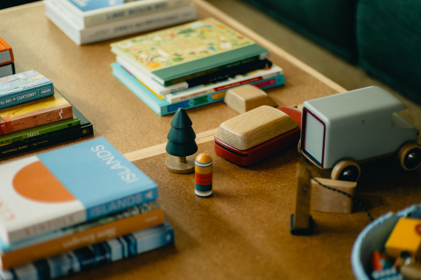 Books and miniature wooden toys arranged on a coffee table.